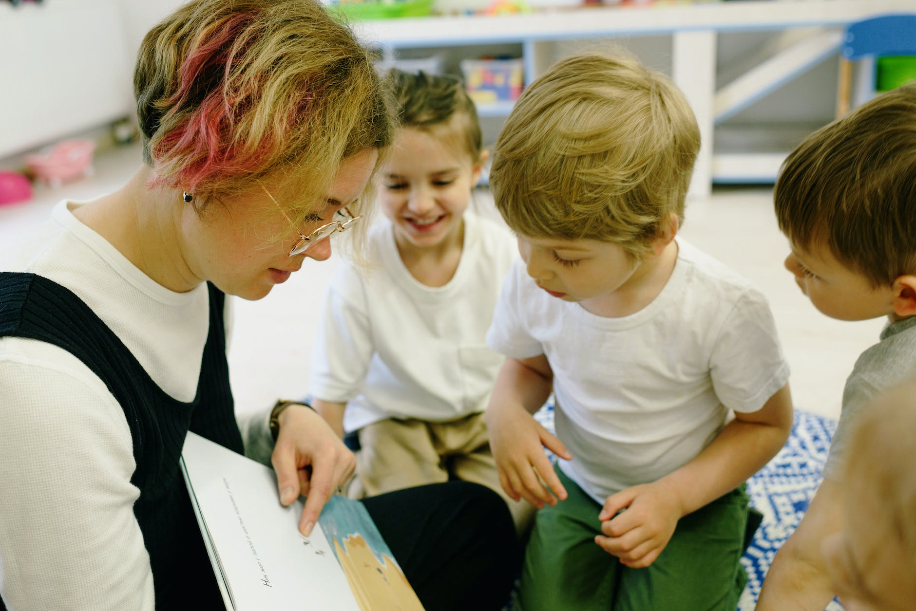 a woman teaching children to read book